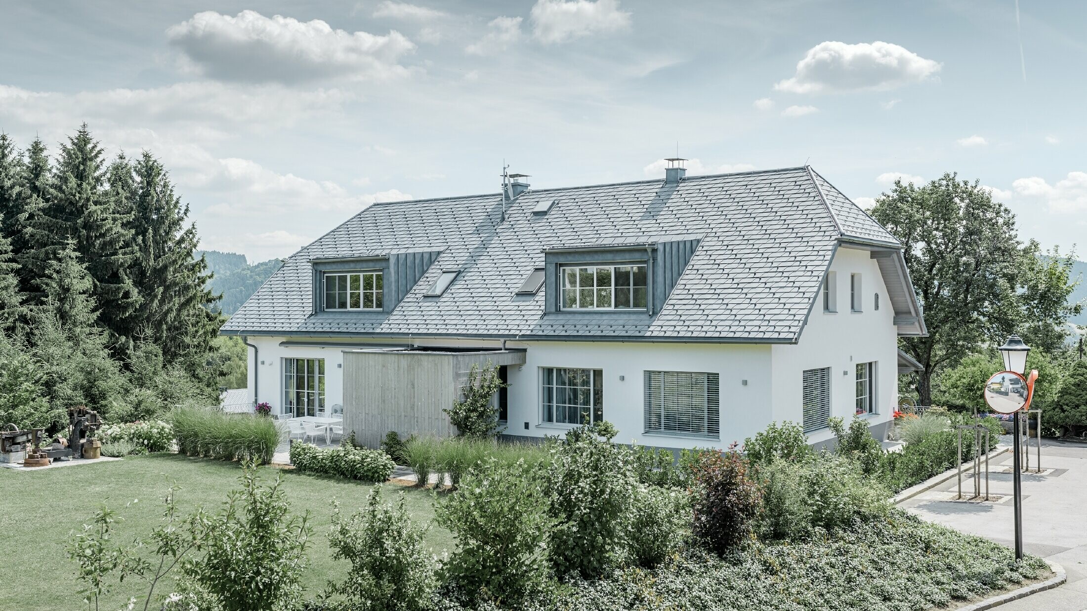 [Translate to česky:] Renovace valbové střechy střešním šindelem PREFA v barvě P.10 břidlicové se dvěma vikýři.